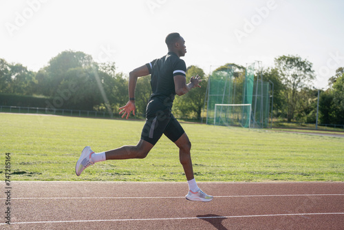 Athlete sprinting at running track