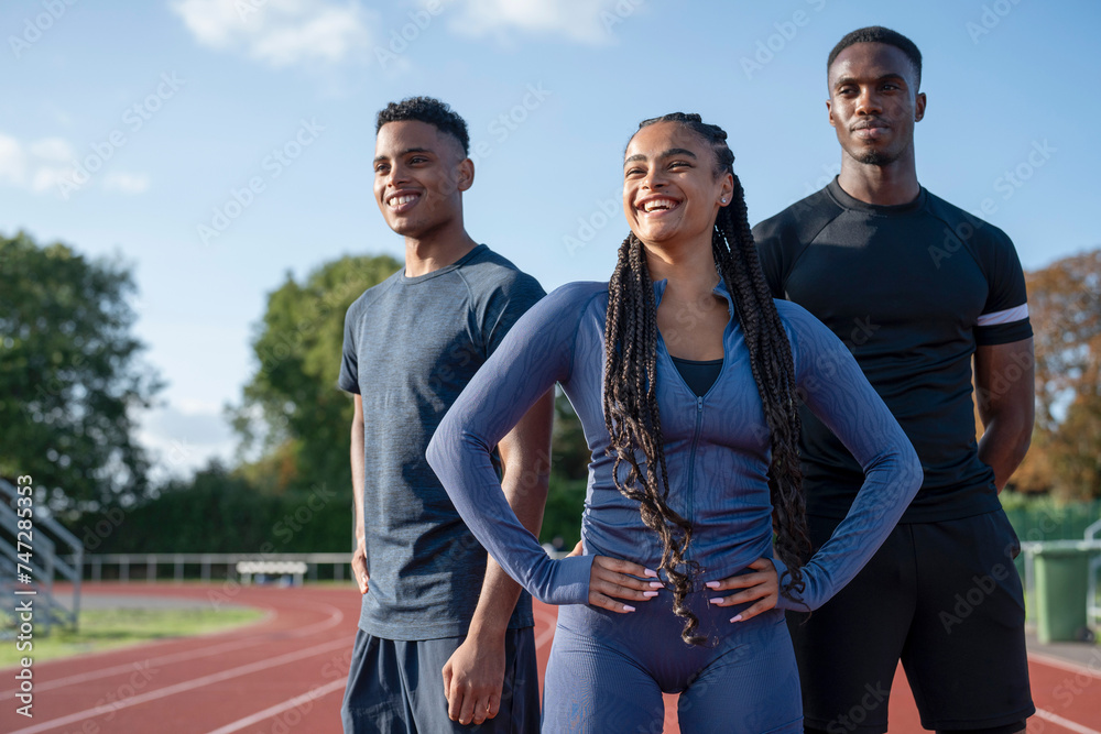 Obraz premium Portrait of group of athletes standing at stadium