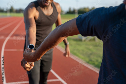 Two athletes running in relay race