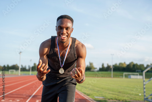 Portrait of athlete celebrating with medal © Cultura Creative
