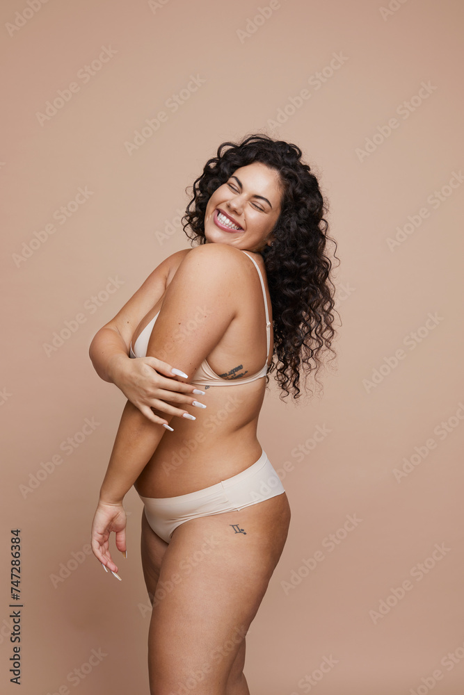 Studio shot of smiling young woman wearing lingerie Studio shot of smiling young woman wearing lingerie