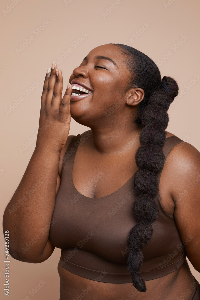 Fototapeta premium Studio shot of smiling young woman with braided hair