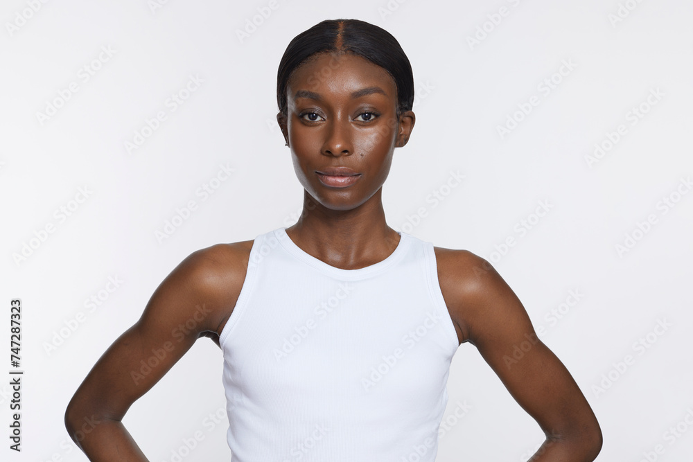Studio portrait of athletic woman in white top