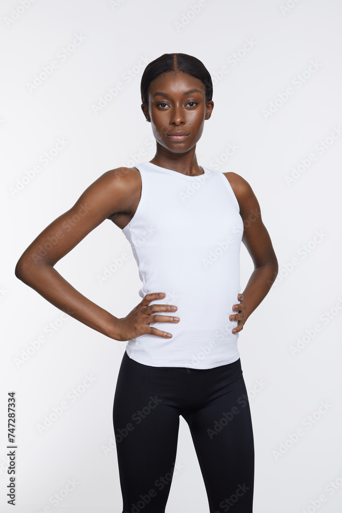 Studio portrait of athletic woman in white top Studio portrait of athletic woman in white top