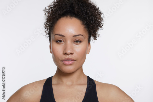 Studio portrait of athletic woman in black top