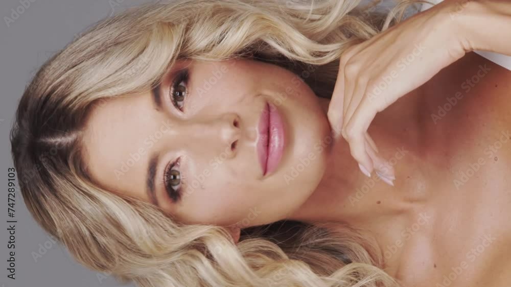 Studio portrait of young and beautiful blond woman over grey background. Skin care and wellness concepts. Studio portrait of young and beautiful blond woman over grey background. Skin care and wellness concepts.