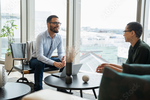 Wall Mural Business people having meeting in office lobby