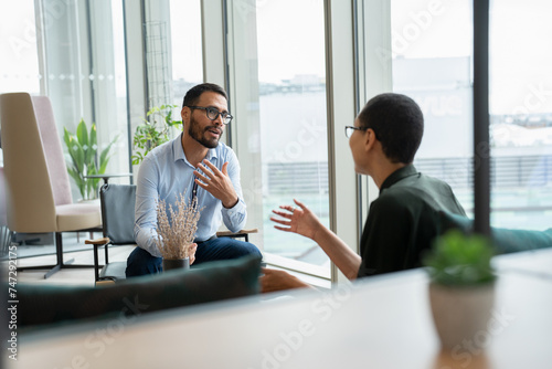Business people having meeting in office lobby