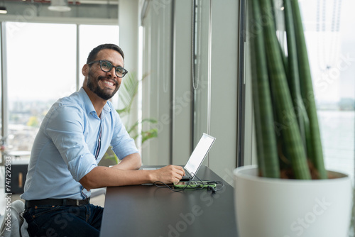 Businessman with laptop working in modern office