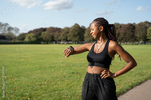 Young woman jogging in park photo