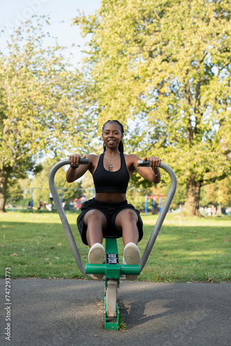 Young woman exercising in outdoor gym