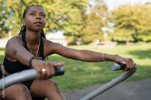 Young woman exercising in outdoor gym