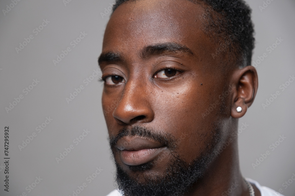 Portrait of man with earring, looking at camera Portrait of man with earring, looking at camera