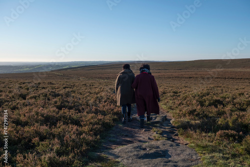 Rear view of two women hiking in moorland
