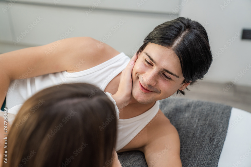 Portrait of a caucasian couple loving bed at home or hotel room together laughing and having fun. Happiness and joyful expression man and a woman celebrating Valentine's Day. Portrait of a caucasian couple loving bed at home or hotel room together laughing and having fun. Happiness and joyful expression man and a woman celebrating Valentine's Day.