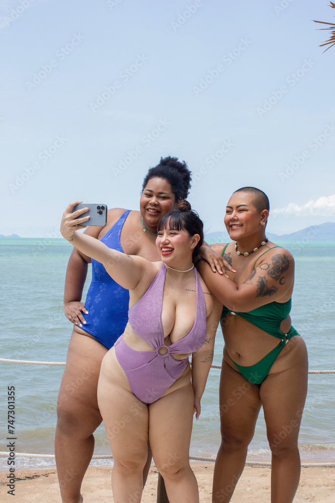Group of cheerful women taking selfie on beach Group of cheerful women taking selfie on beach