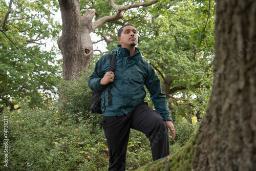 Man with backpack hiking in forest