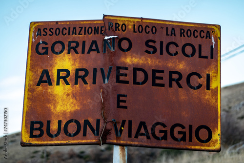 Goriano Sicoli, Italy A rusty old sign at the edge of town says in Italian, Goodbye and Have a nice trip, Arrivederci e Buon Viaggio. photo