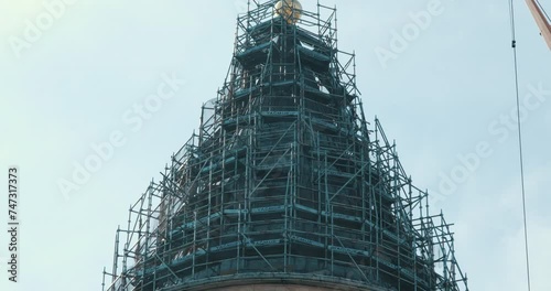 This is the view of the scaffolding established for the restoration of the historical Galata Tower. A bird passes twice. photo
