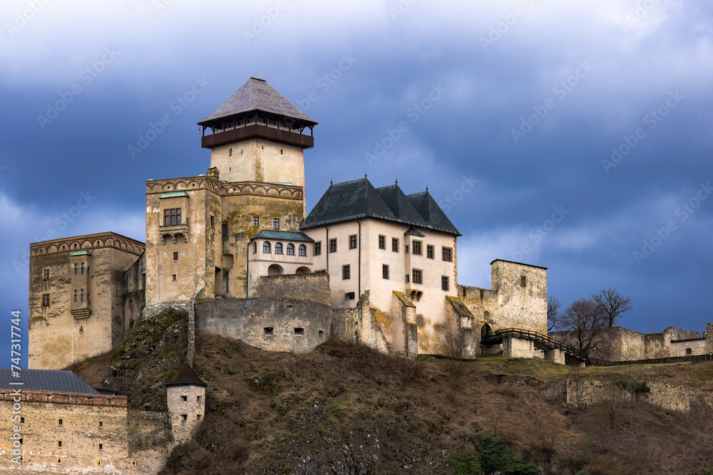 Trenčín castle during the winter without snow, with a cloudy sky with dark clouds.