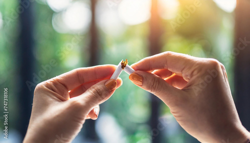 Hands break cigarette, symbolizing quitting smoking © Your Hand Please