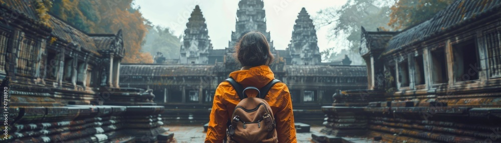Naklejka premium Exploring Ancient Wonders of Cambodia. Amidst the Timeless Ruins and Towering Temples, Travelers Embark on a Quest Through History and Heritage