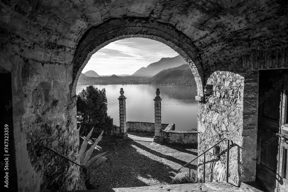 Mountain View from Church Entrance Oratory of S.Antonio da Padova in Santa Maria del Sasso with Mountain and Lake Lugano in a Sunny Day in Morcote, Ticino in Switzerland. Mountain View from Church Entrance Oratory of S.Antonio da Padova in Santa Maria del Sasso with Mountain and Lake Lugano in a Sunny Day in Morcote, Ticino in Switzerland.