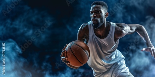 African american man playing basketball on black background with smoke effect.