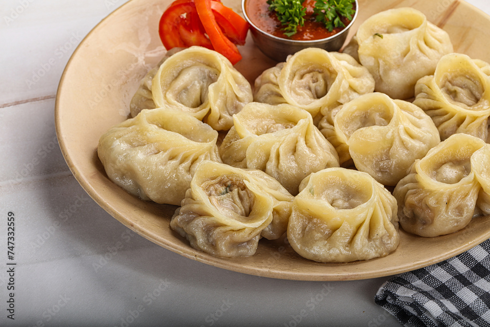 Steamed Nepali dumpling Momo with sauce Steamed Nepali dumpling Momo with sauce