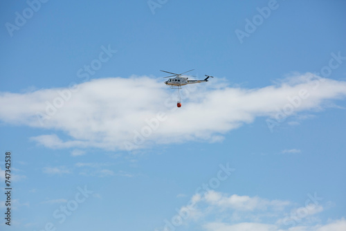 firefighting helicopter hydrating a fire