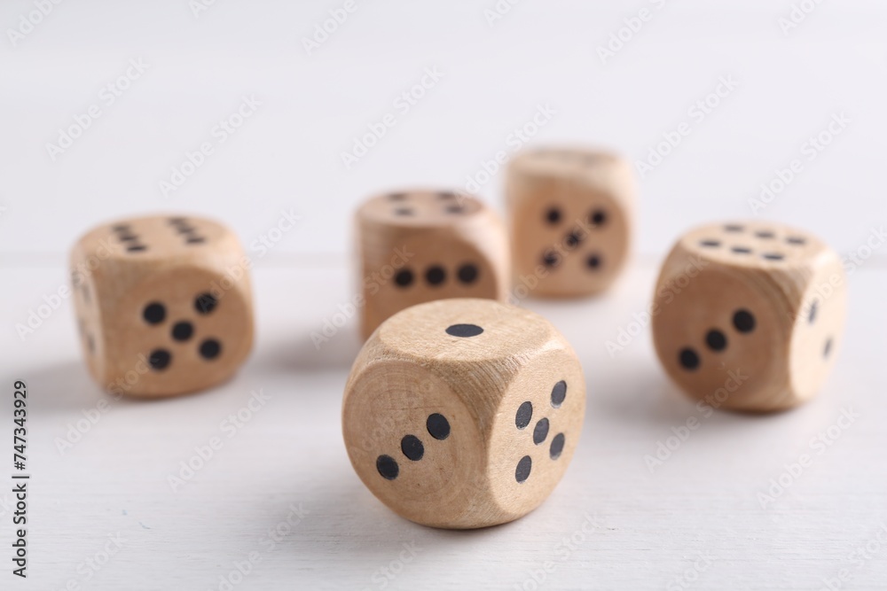 Many game dices on white wooden table, closeup Many game dices on white wooden table, closeup