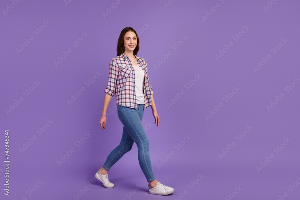 Full size profile photo of attractive pretty lady good mood walking wear casual sneakers isolated shine color background Full size profile photo of attractive pretty lady good mood walking wear casual sneakers isolated shine color background