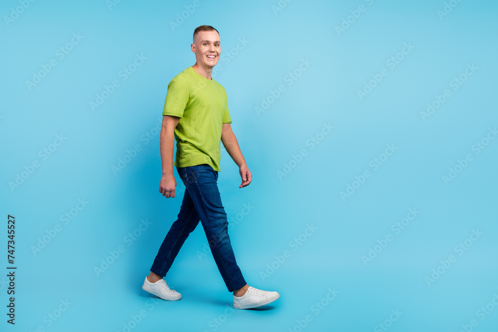Full length body size photo smiling man in casual clothes walking isolated blue color background