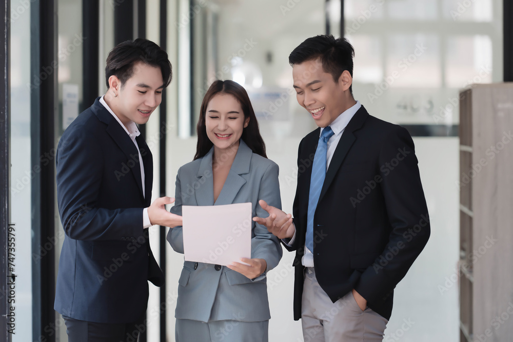 Young motivated Asian business team discussing oh business strategy in the modern meeting room. Young motivated Asian business team discussing oh business strategy in the modern meeting room.