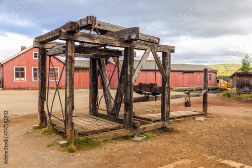 The remnants of an old mine elevator stand as a historical monument in Roros, surrounded by the town's distinctive wooden buildings and mining heritage. Norway