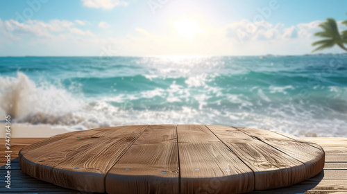 A wooden platform table for product advertising, a circular podium positioned in front of the vast ocean, provides a clear and unobstructed view of the water and horizon photo
