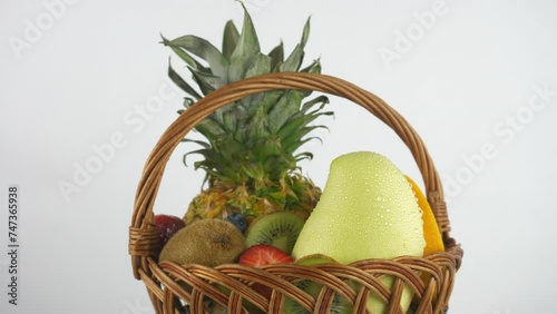 Ripe juicy pineapple and fruits in a basket