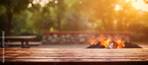 Empty barbecue table with fire burning in background  © Media Srock