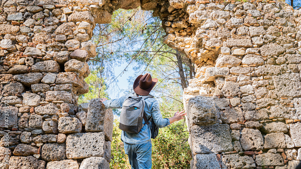 An archaeologist is a tourist in the jungle on the background of ancient ruins