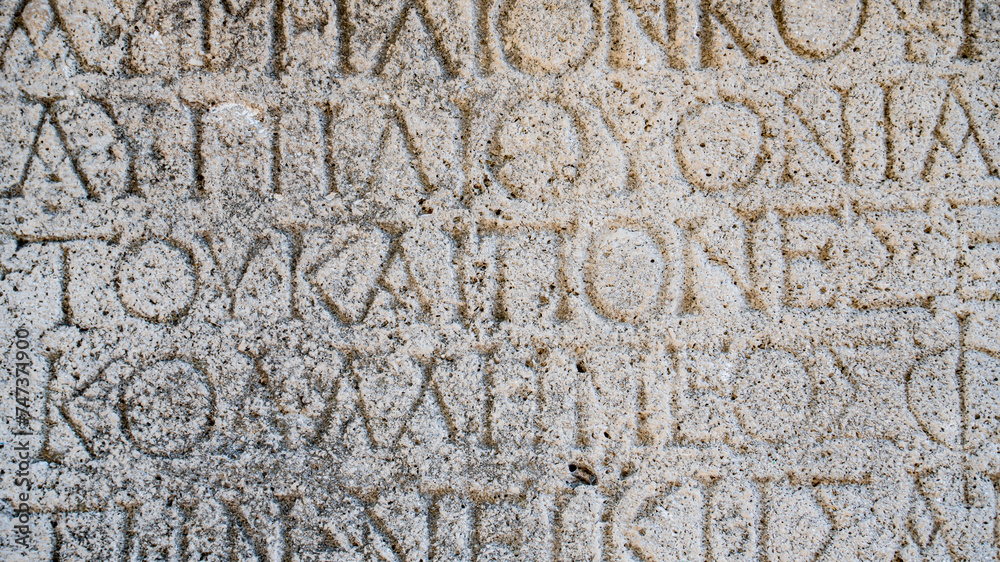 Close-up  background of ancient Greek writings on the ruins of an ancient city