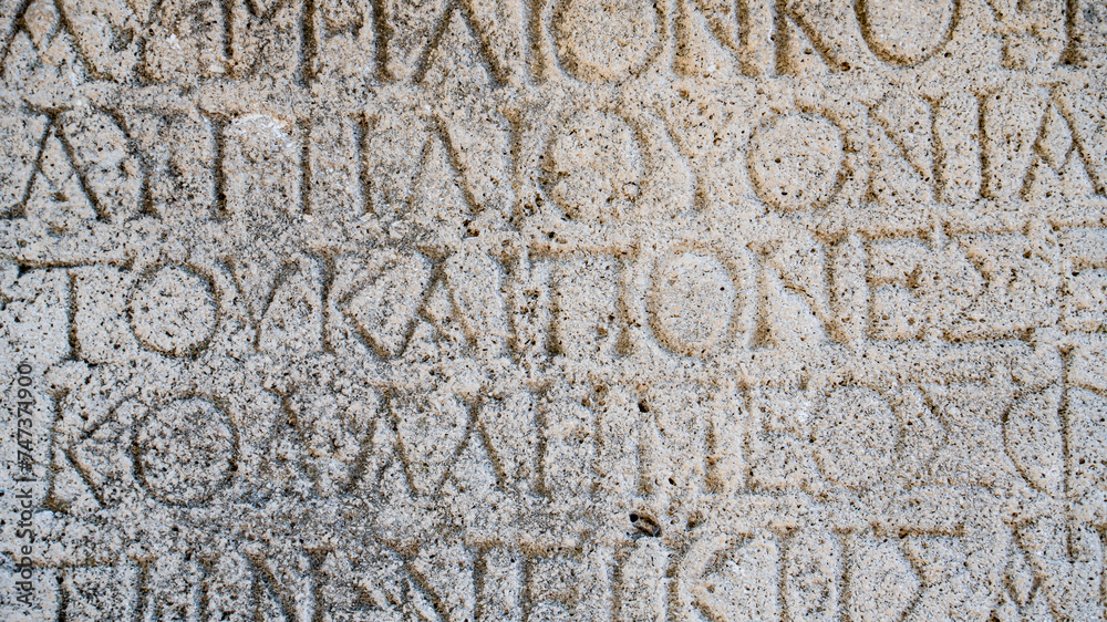 Close-up background of ancient Greek writings on the ruins of an ancient city Close-up background of ancient Greek writings on the ruins of an ancient city