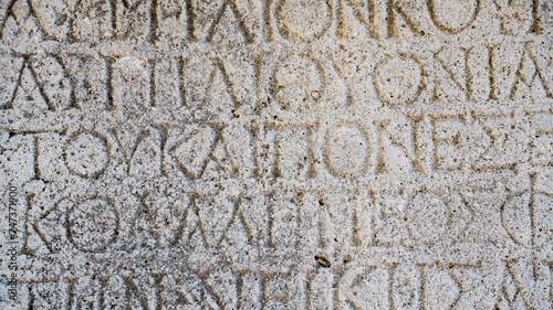 Close-up background of ancient Greek writings on the ruins of an ancient city