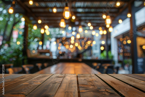 wooden table in front of abstract blurred background of resturant, night cafe lights for ifestyle and celebration concepts ideas.
