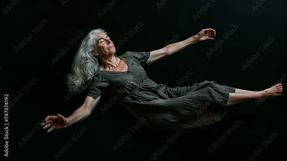 A woman floating in darkness