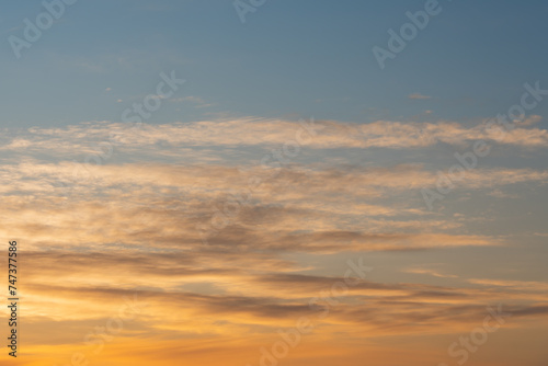 Photo background texture of orange sky at sunset with clouds. © Dmitri