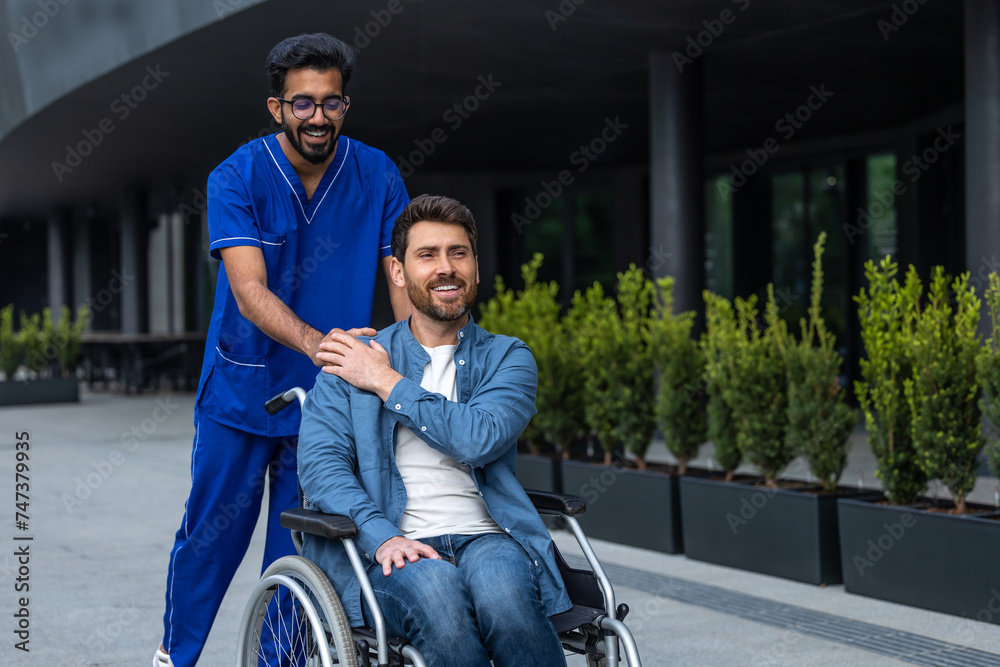 Smiling confident man in wheelchair having a walk with a male nurse Smiling confident man in wheelchair having a walk with a male nurse