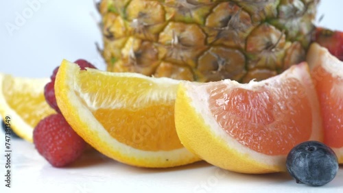Ripe juicy pineapple and slices of orange and grapefruit