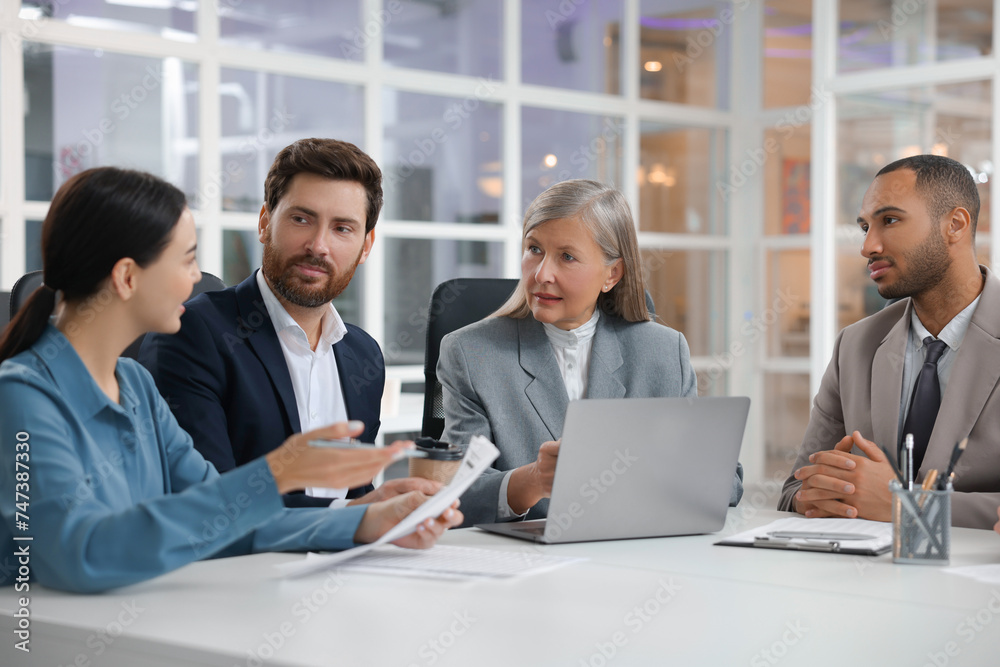 Lawyers working together at table in office Lawyers working together at table in office
