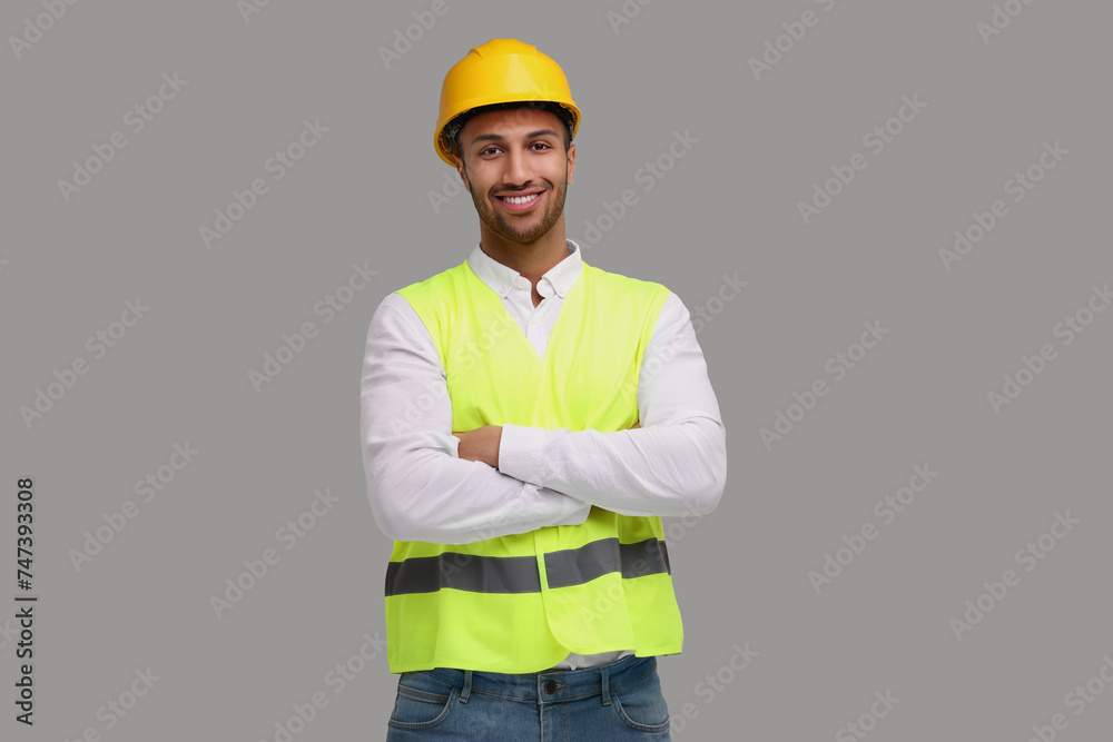 Engineer in hard hat on grey background Engineer in hard hat on grey background
