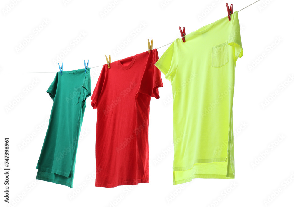 Colorful t-shirts drying on washing line isolated on white